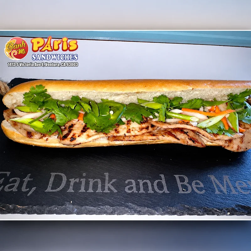 Grilled meat bánh mì with cilantro and pickled vegetables at Banh Mi Paris Sandwiches